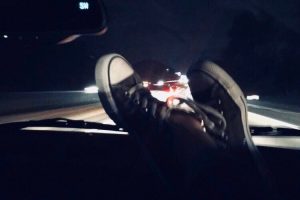 Picture of high-top shoes on car dashboard